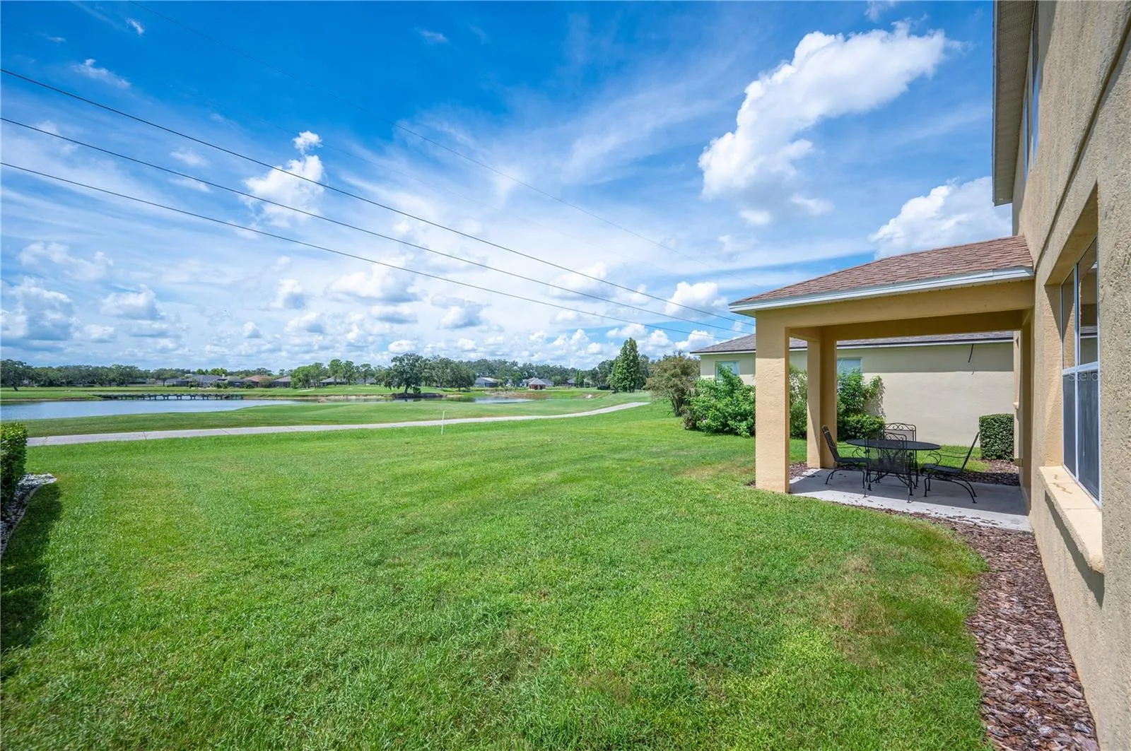 The back yard is spacious and has room for a pool