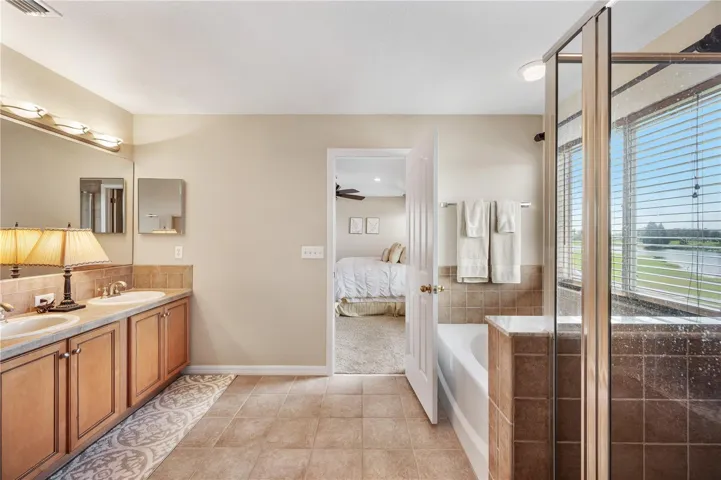 The Primary en-suite bath boasts a large walk in shower , dual vanities, garden jetted tub .