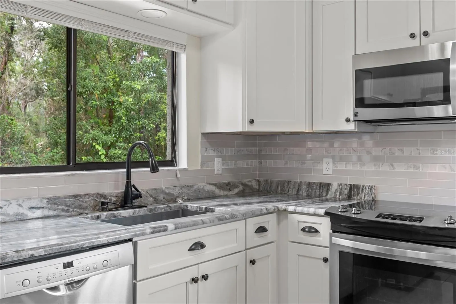 White Shaker Soft Close Cabinets with Subway Tile Backsplash