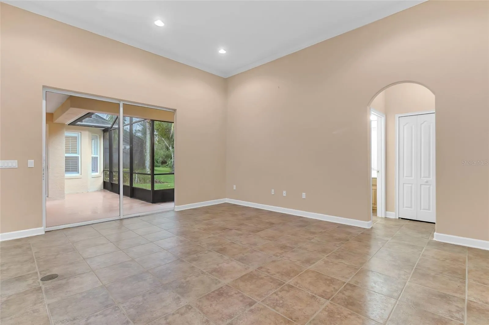 Family Room. Bathroom 3 & Bedroom 4 to the Right, Screened in Patio to the Left.