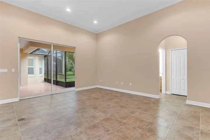 Family Room. Bathroom 3 & Bedroom 4 to the Right, Screened in Patio to the Left.