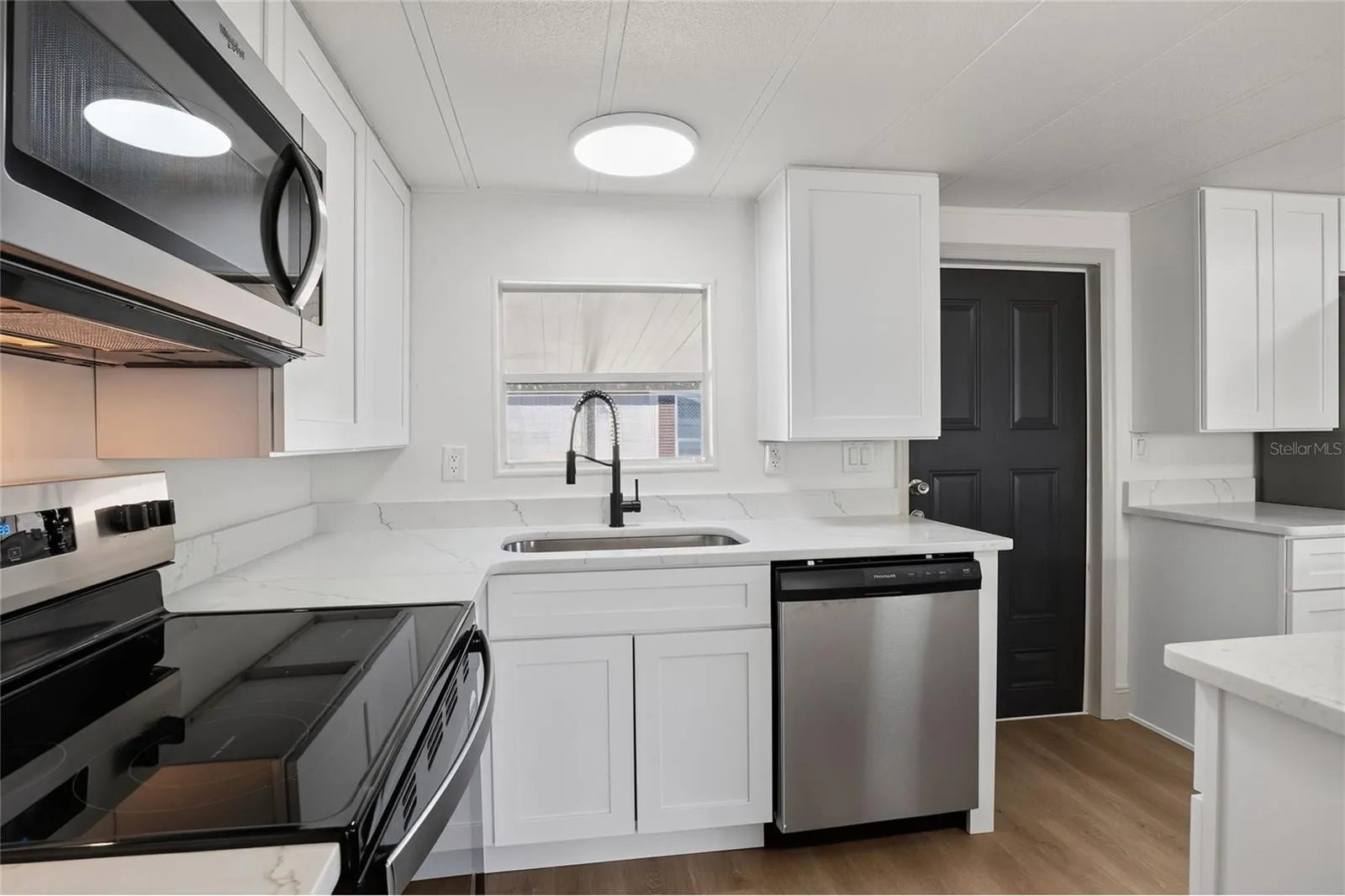 Shaker cabinets, solid-surface counter tops, and stainless finish appliances