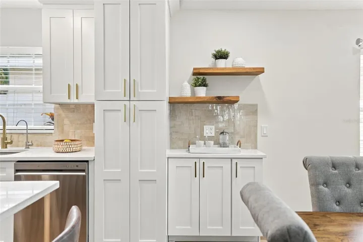 Extra pantry storage and a coffee bar with floating shelves.  Every detail has been taken care of!