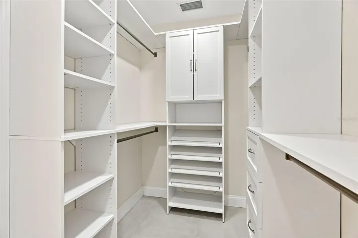 A walk-in closet with custom built-ins for the ultimate in organization.