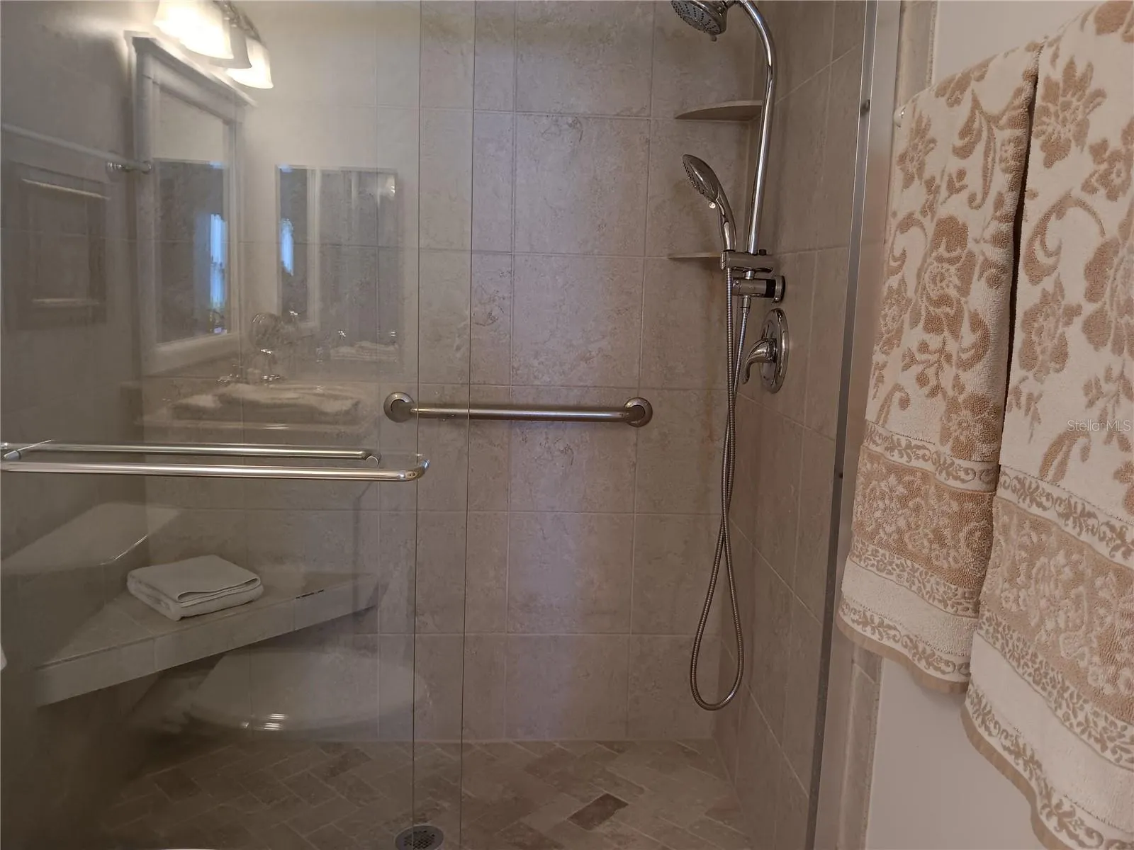 Primary shower offers a bench for your convenience.
