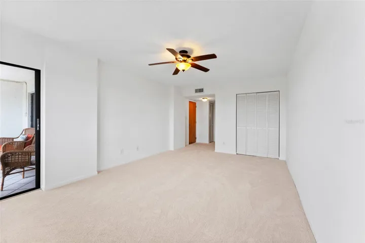 The primary bedroom is oversized, and has loads of closet space.  You also have access to your screened lanai from here.