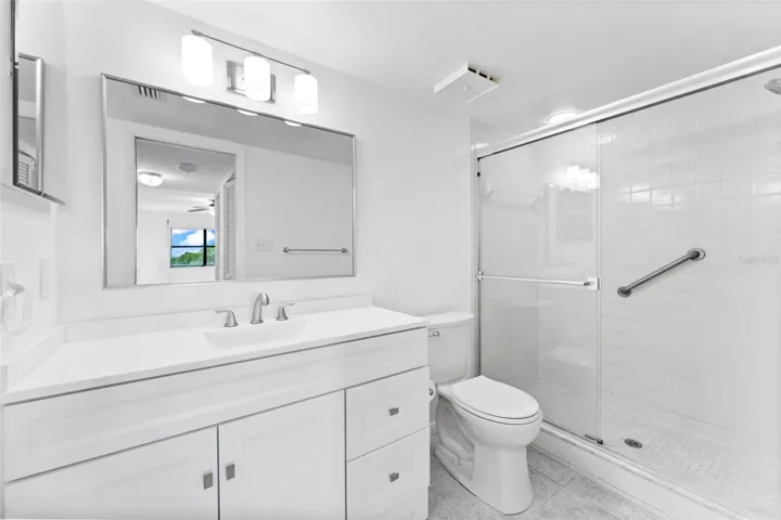 Primary bathroom with new vanity, lighting and toilet.