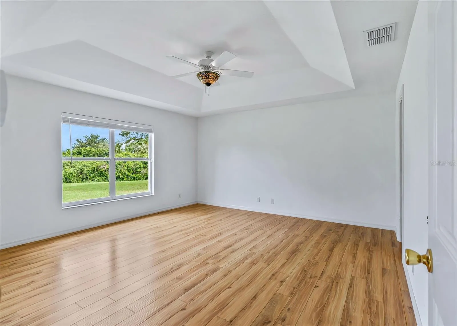 Primary Bedroom with accent ceiling