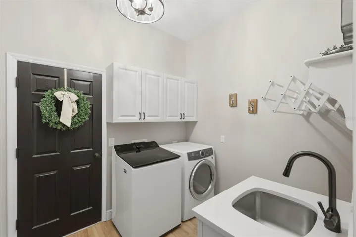 Laundry room is adjacent to primary suite.