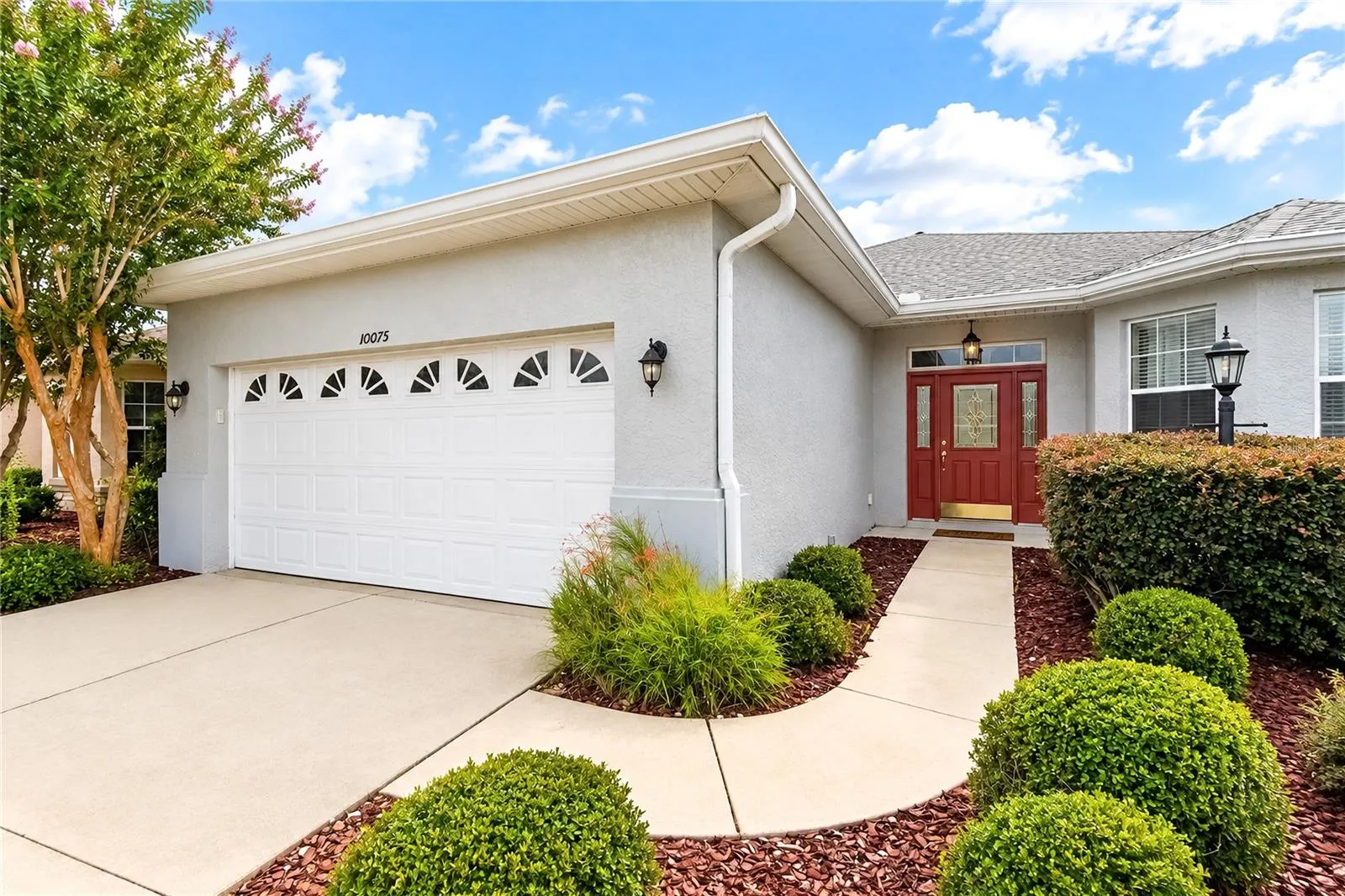 2 car Garage with a sidewalk to front entry