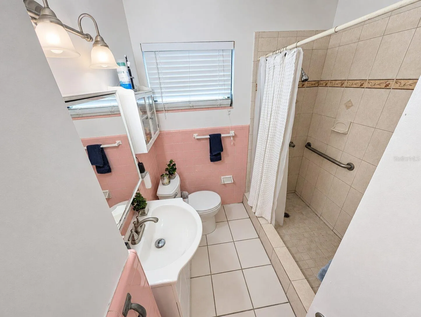 Bathroom, shower stall with handrail