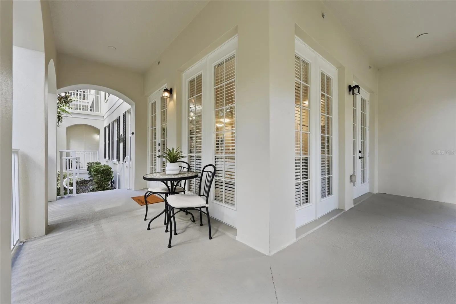 Expansive covered outdoor living space wraps around this desirable ground-floor corner residence.