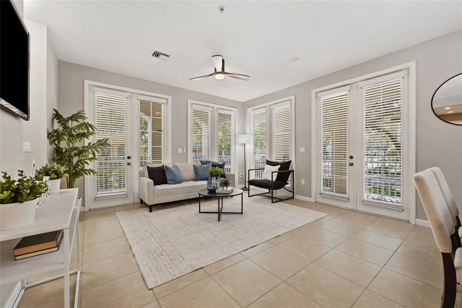 Corner-unit design provides exceptional natural light with multiple sets of French doors opening to the covered outdoor living areas.