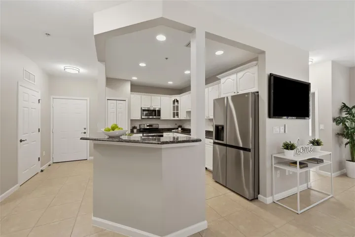 Spacious kitchen opens to the main living area and features generous cabinetry, granite countertops and stainless-steel appliances.
