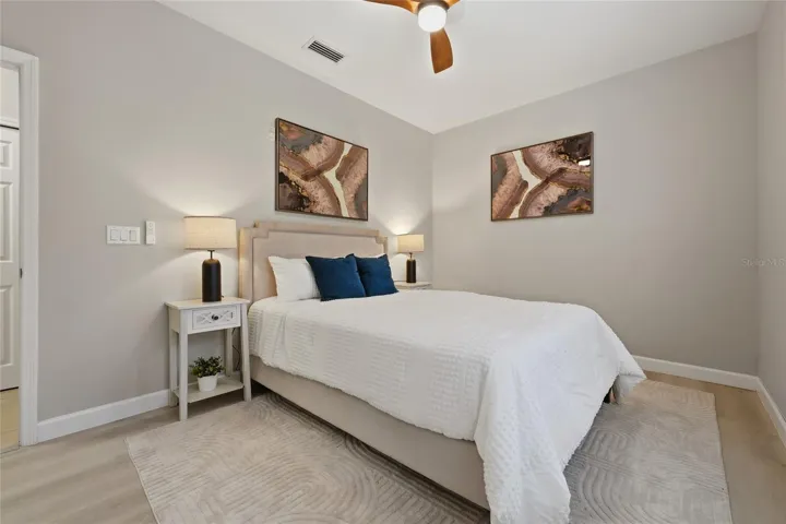 Another view of the secondary bedroom highlights its comfortable proportions and neutral finishes.