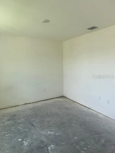 Living Room with concrete flooring. Waiting for your choice of floor covering.
