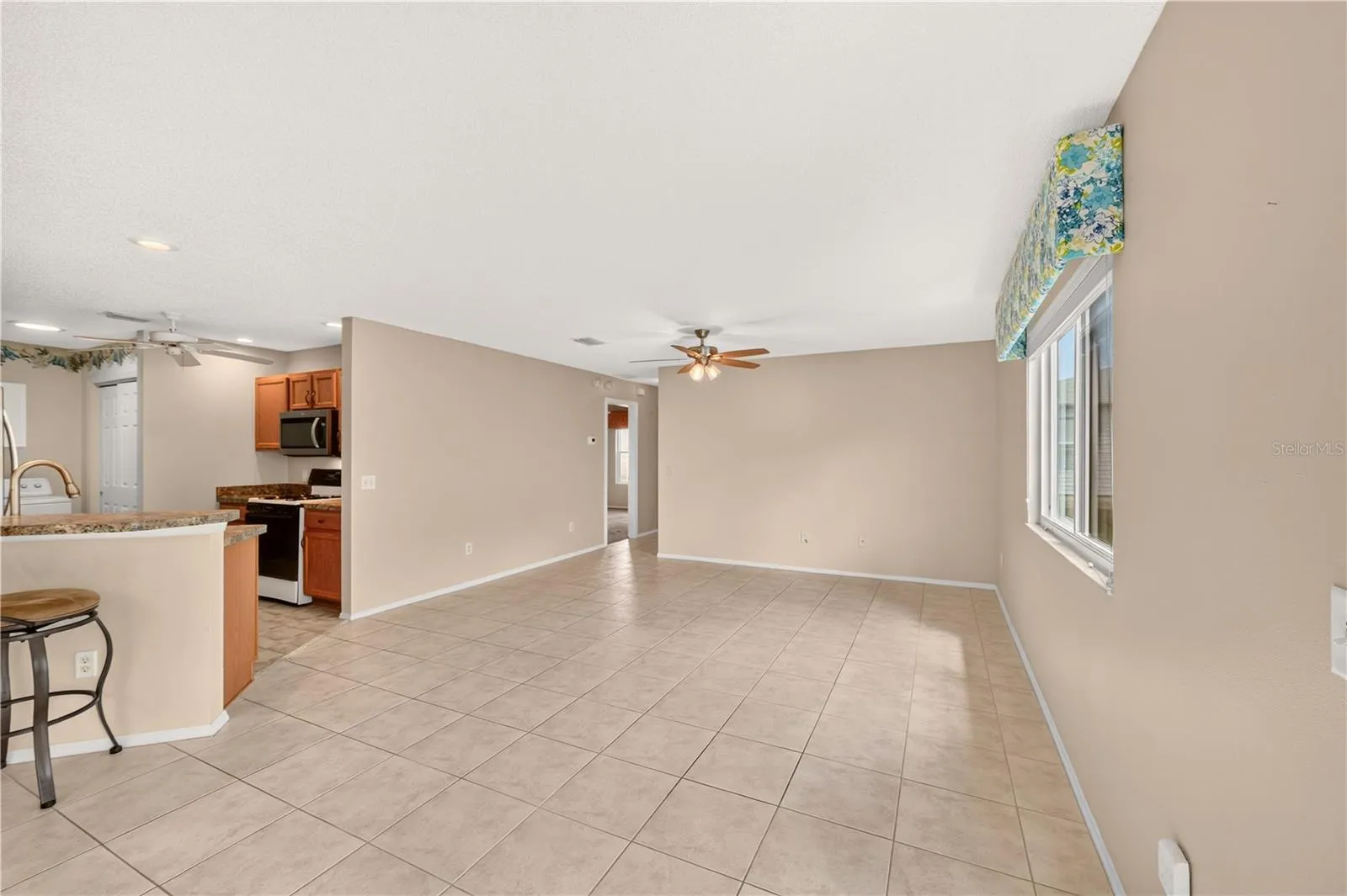 A great view of the main living room and a peek at the kitchen on the left.