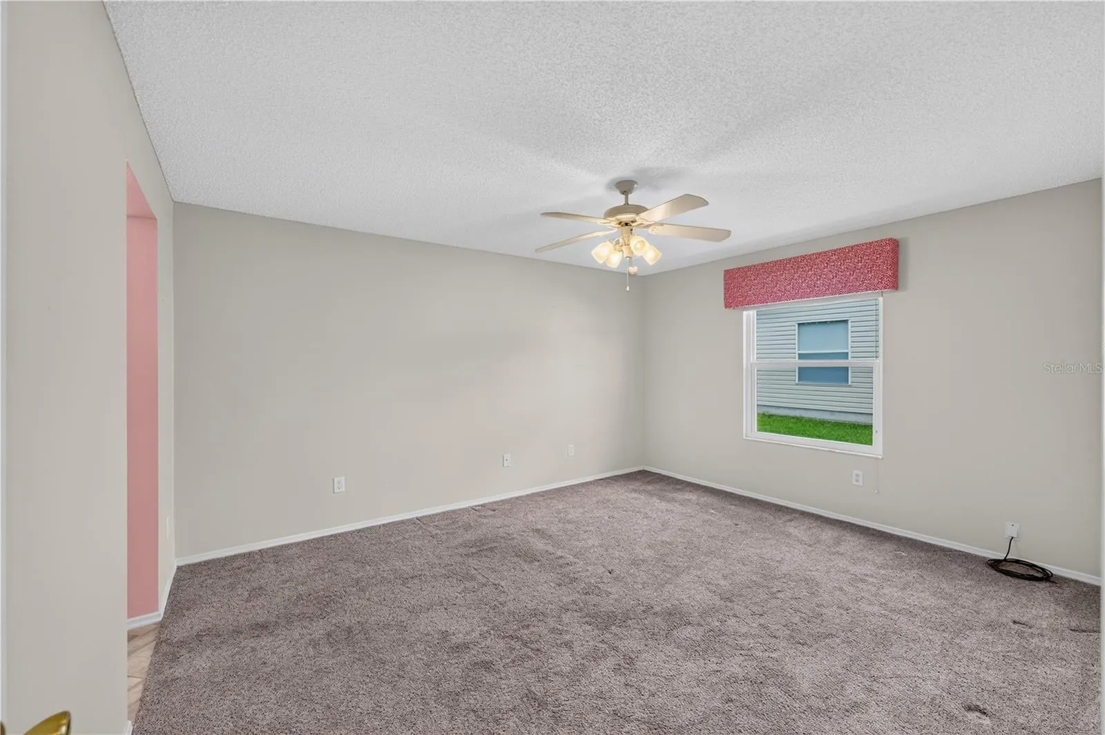 The spacious primary bedroom has newer carpet.