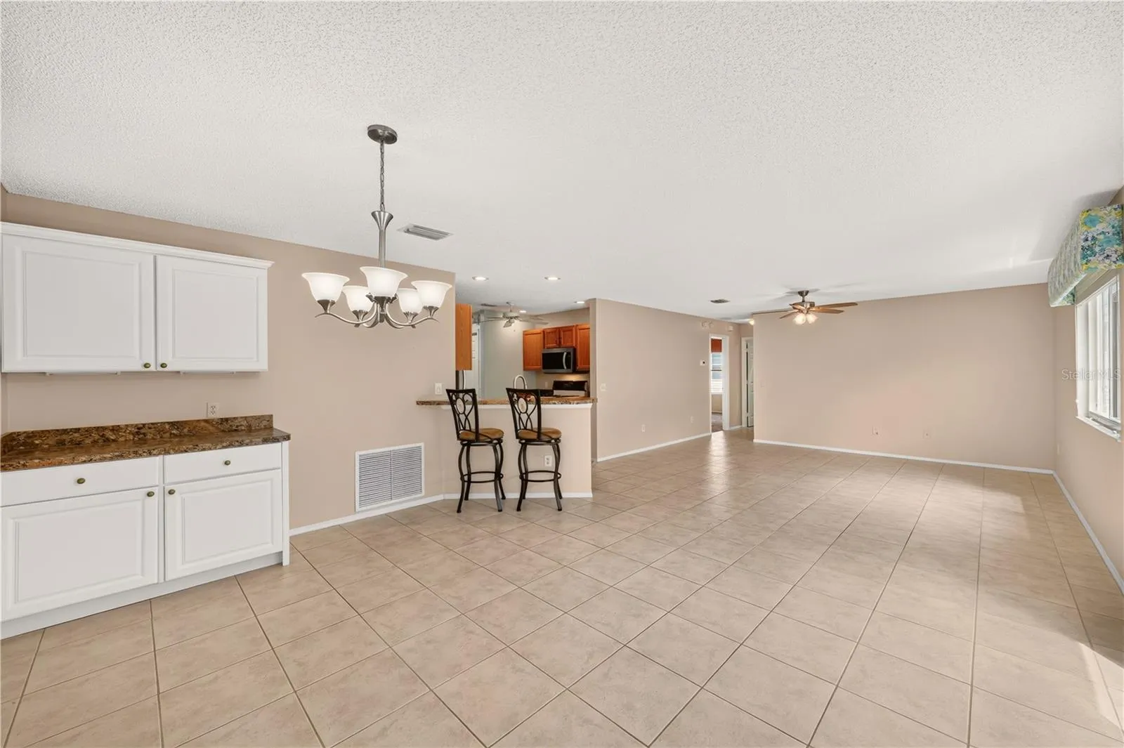 The custom cabinet and bar stools are a welcome addition to the property.