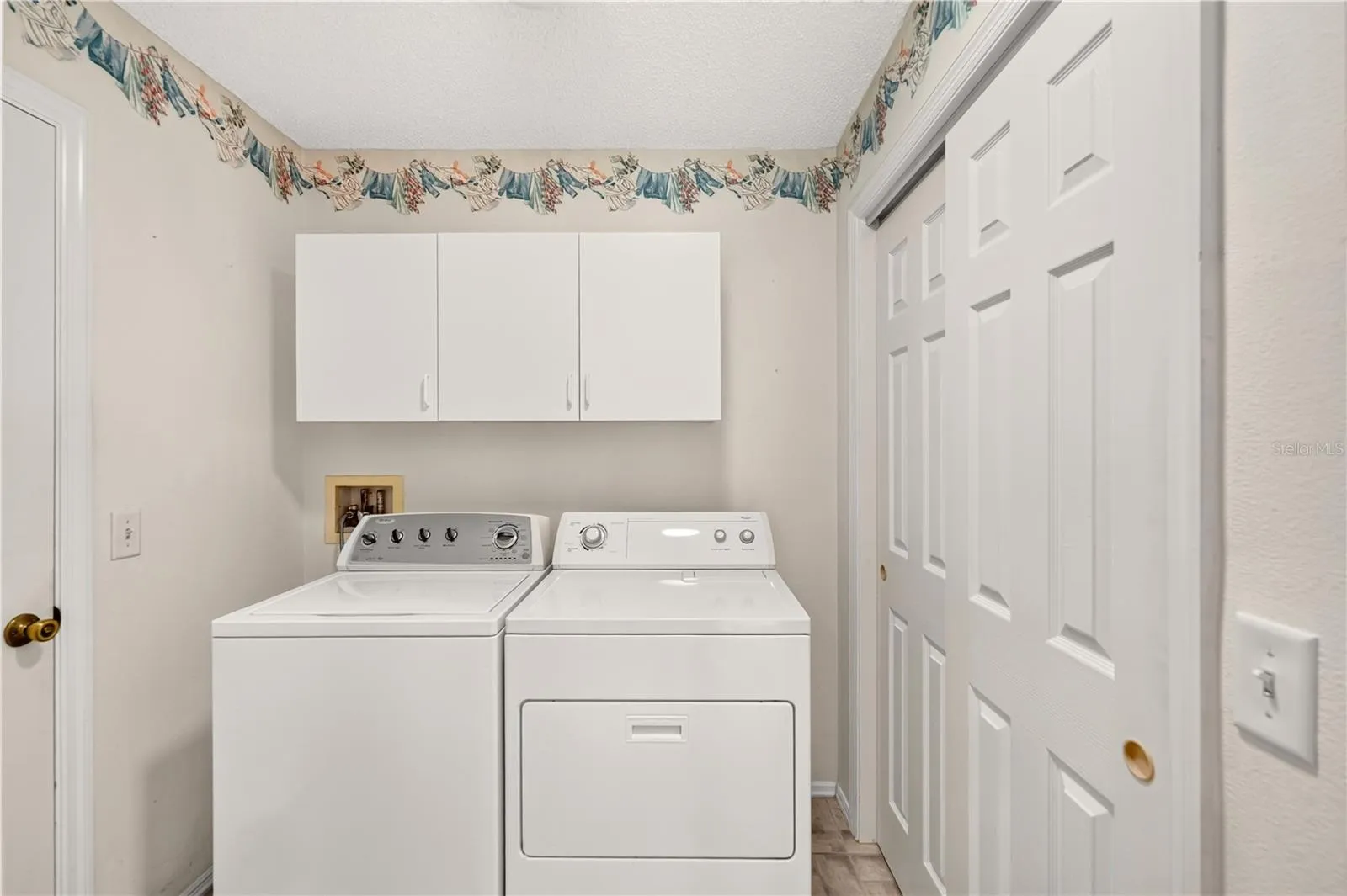 The indoor laundry has tons of storage, including a closet.