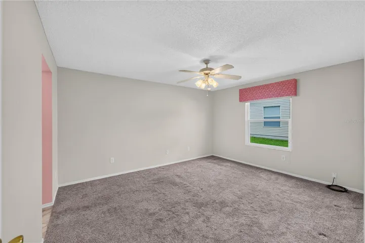 The spacious primary bedroom has newer carpet.