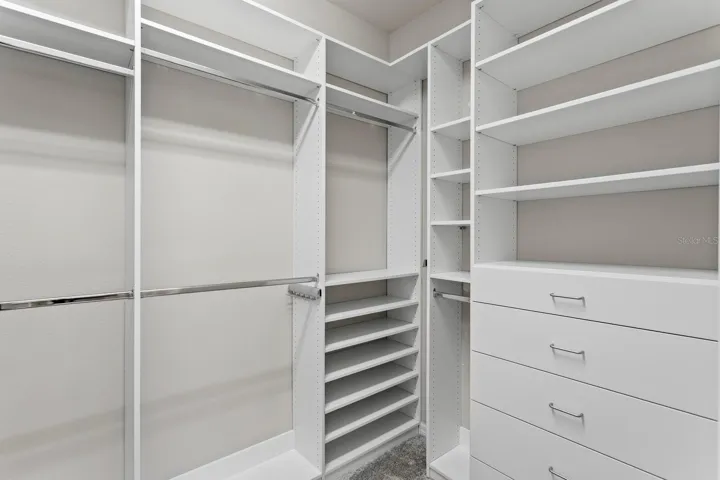 Custom organizer in large walk-in-close in primary suite