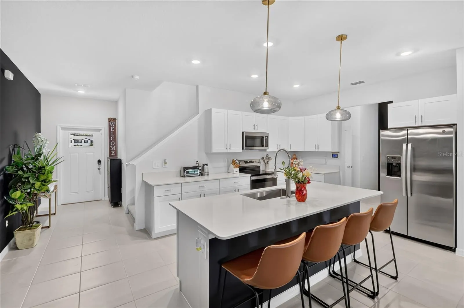 Upgraded pendant lighting in the kitchen over the island