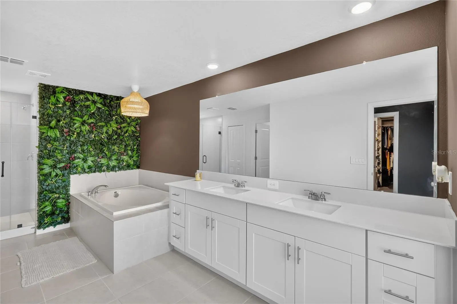 Primary bathroom has two sinks, soaking tub and walk-in shower.