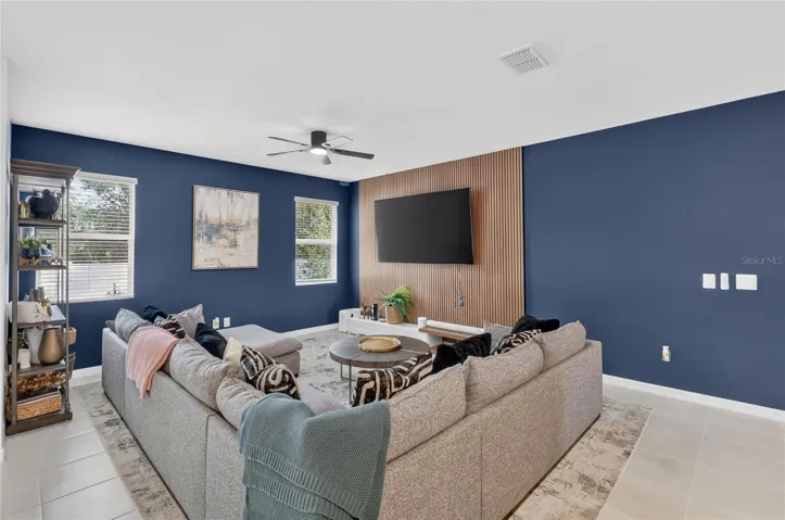 Living room with accent wall and updated tv mount.