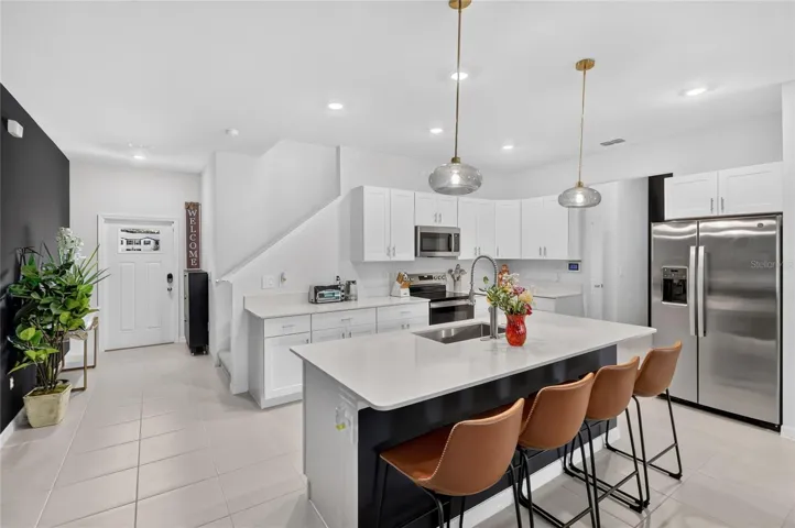 Upgraded pendant lighting in the kitchen over the island