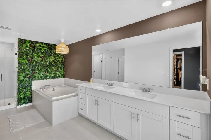 Primary bathroom has two sinks, soaking tub and walk-in shower.