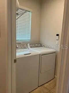 Washer and Dryer Laundry Room has a nice window and built in shelving.