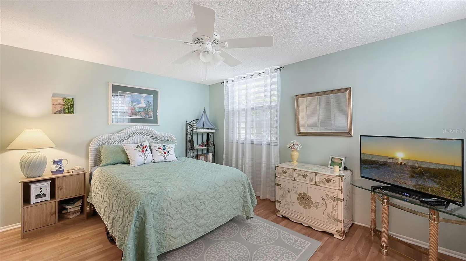 The guest bedroom is light and bright with windows on both exterior walls.