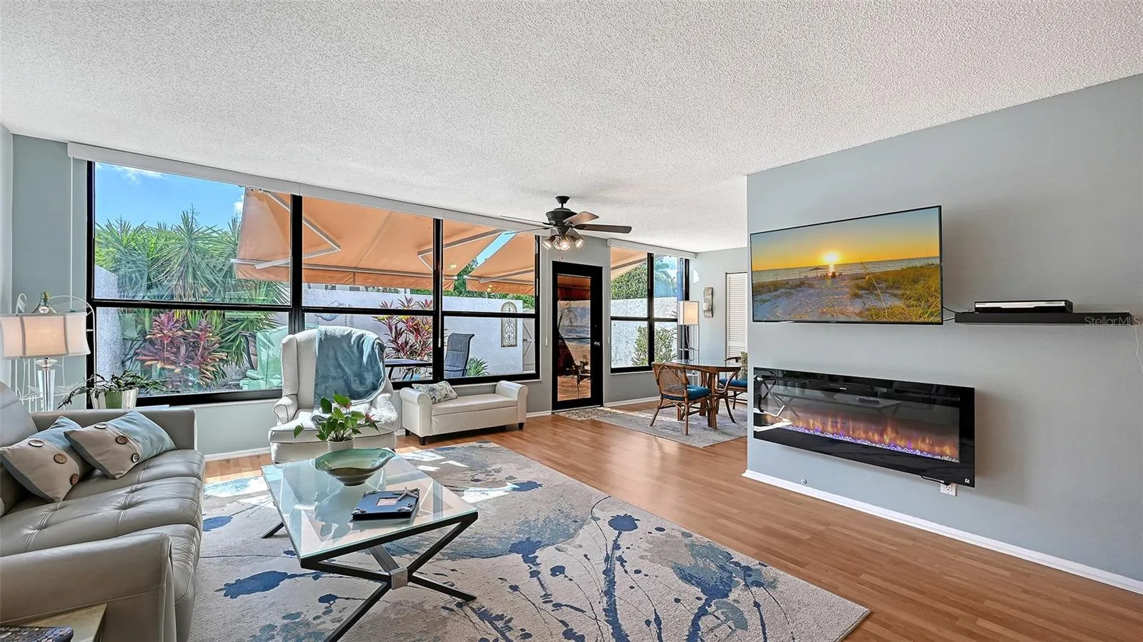 Living room with a peak around the cornet into what was the lanai section behind master bedroom. Area can be screened off with a folding blind for crafts area or office.