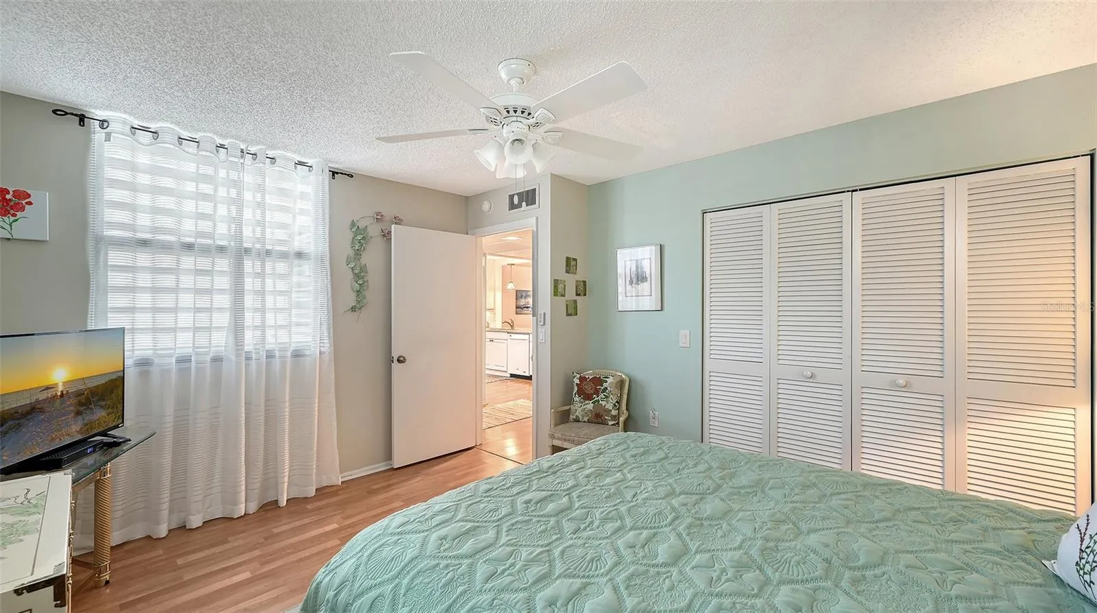 The guest bedroom features a long reach-in closet