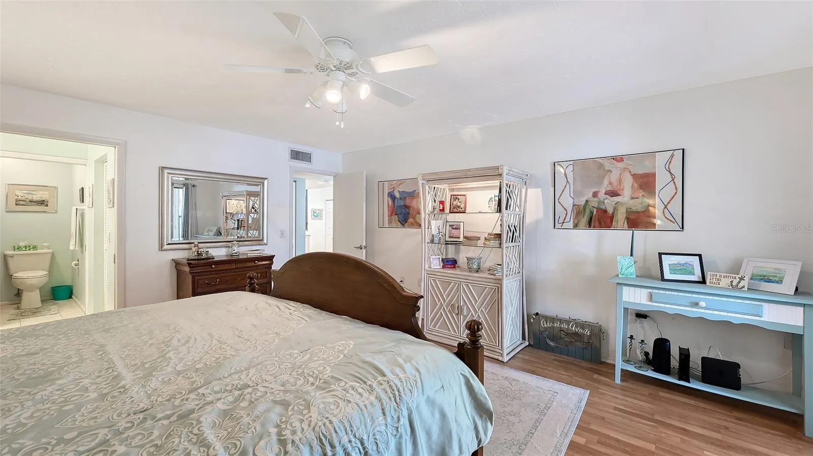 The main bathroom/walk-in closet are behind a pocket door on the left side of the photo
