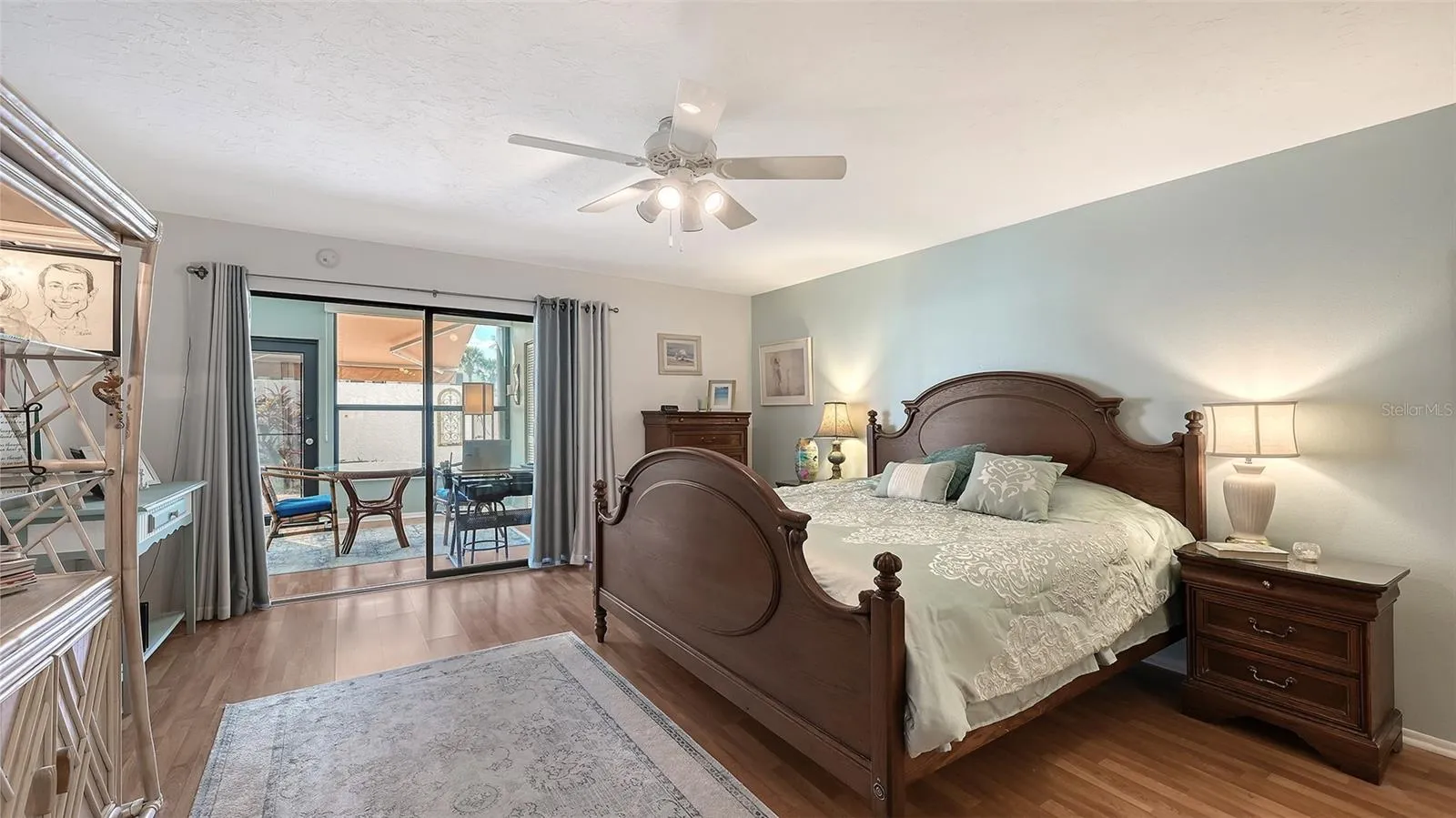 The view is into the former lanai area that is furnished with a breakfast table and a small desk.