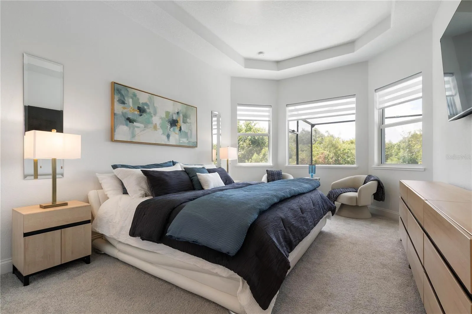 Luxurious Primary Bedroom with Bay windows overlooking the pool