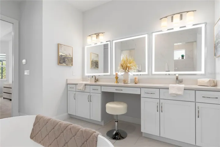 Dual vanities with sitting area and LED mirrors