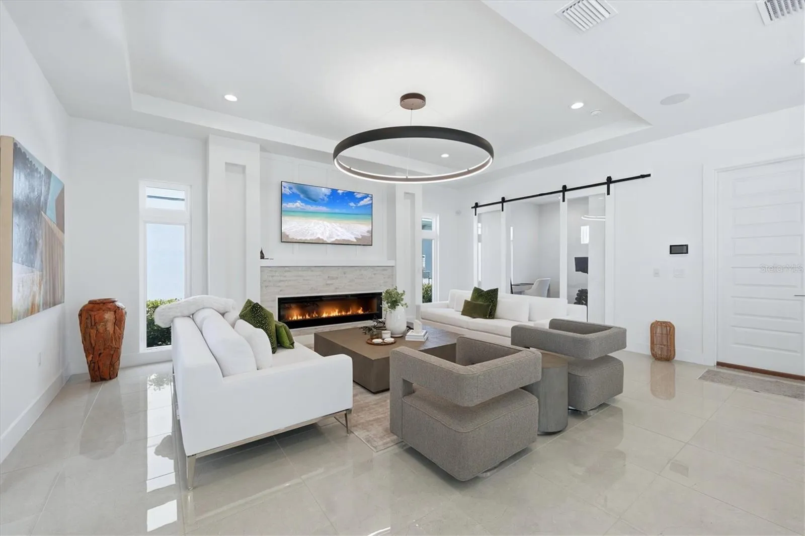 family room with electric fireplace and stone wall accent