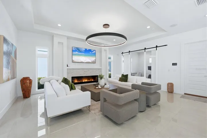 family room with electric fireplace and stone wall accent