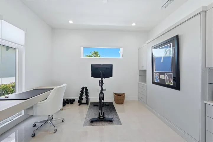 home office with barn doors and Murphy bed/cabinets for impromptu guests