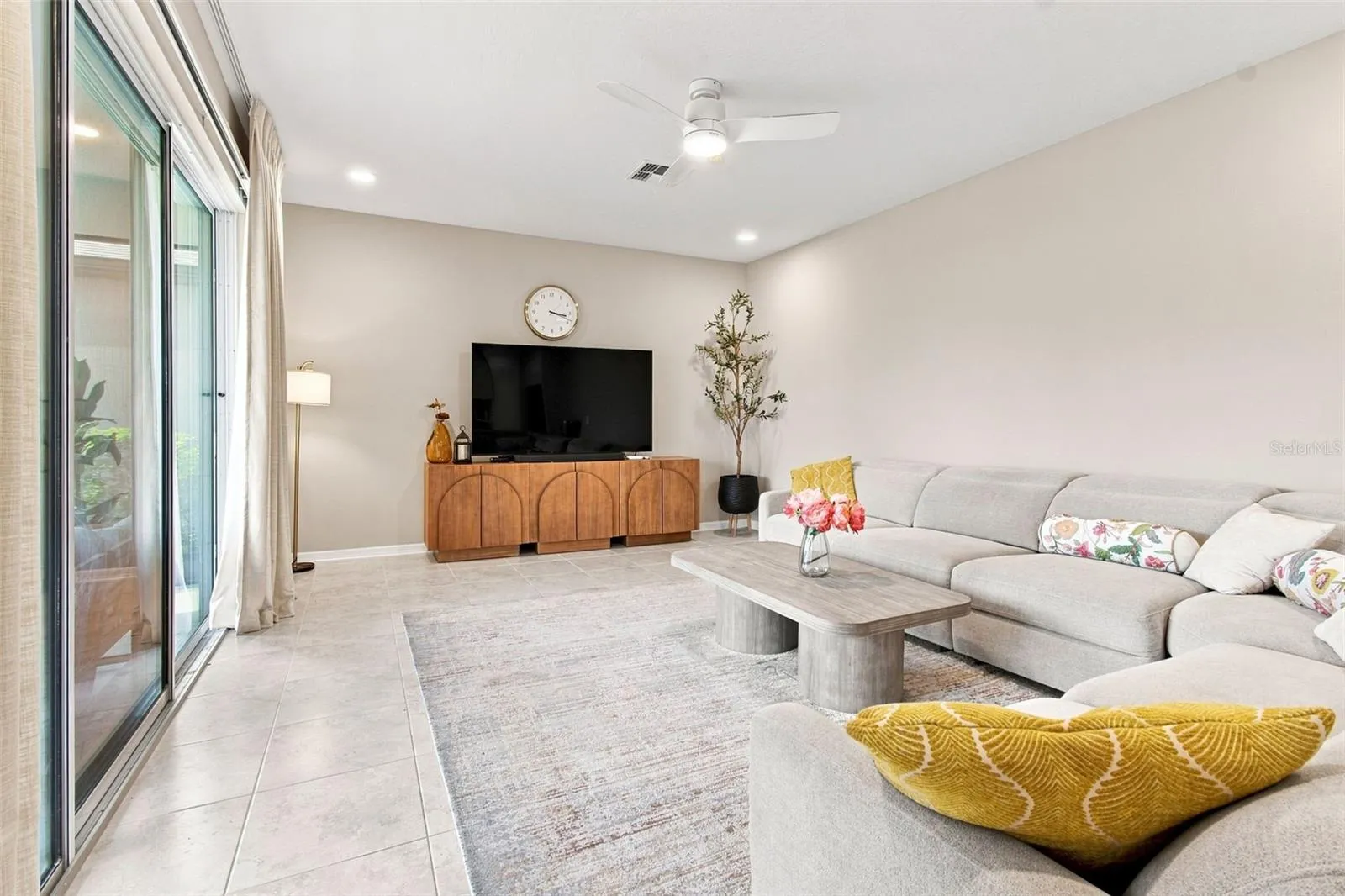 Beautiful porcelain tile floors throughout the living, dining, and kitchen areas