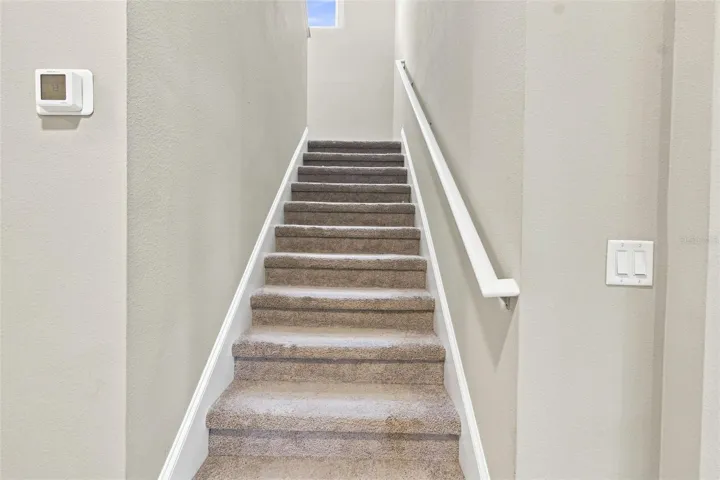Staircase leading to the family room and three bedrooms
