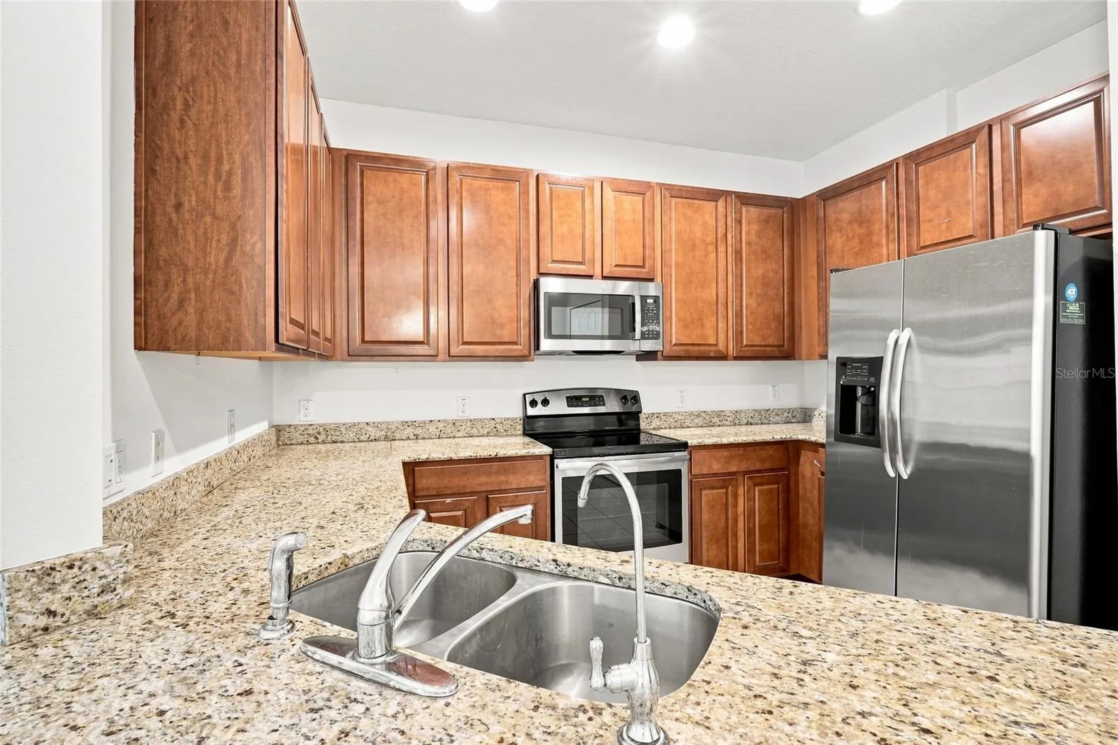 Kitchen with granite countertops and stainless-steel appliances