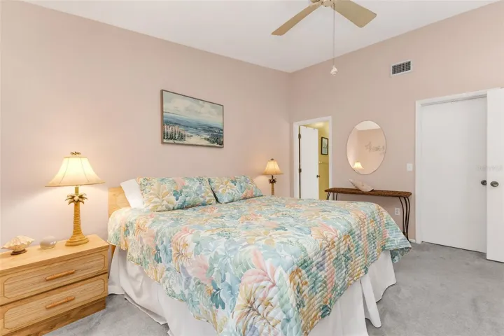 The spacious primary suite offers privacy from the guest bedroom along with direct access to the screened lanai, creating an easy indoor-outdoor connection