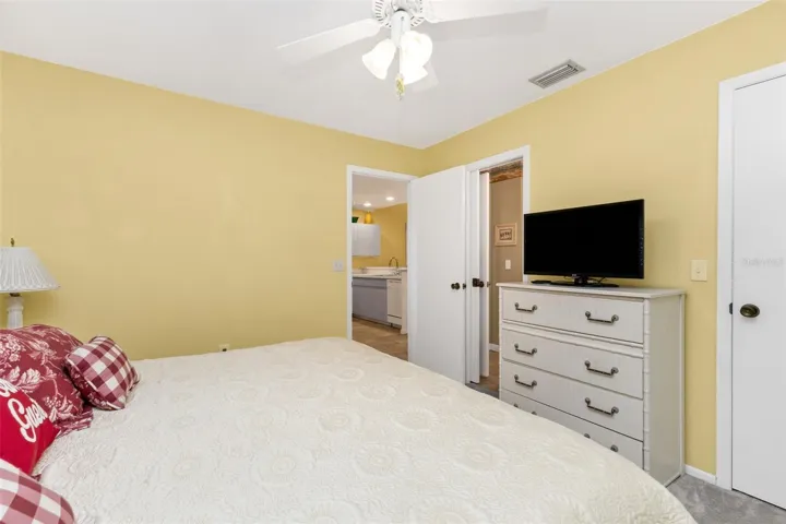 Guest bedroom with dresser, comfortable bedding, walk in closet.