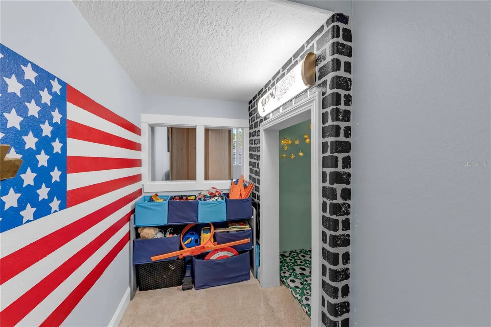 Play nook under stairs with peep through
