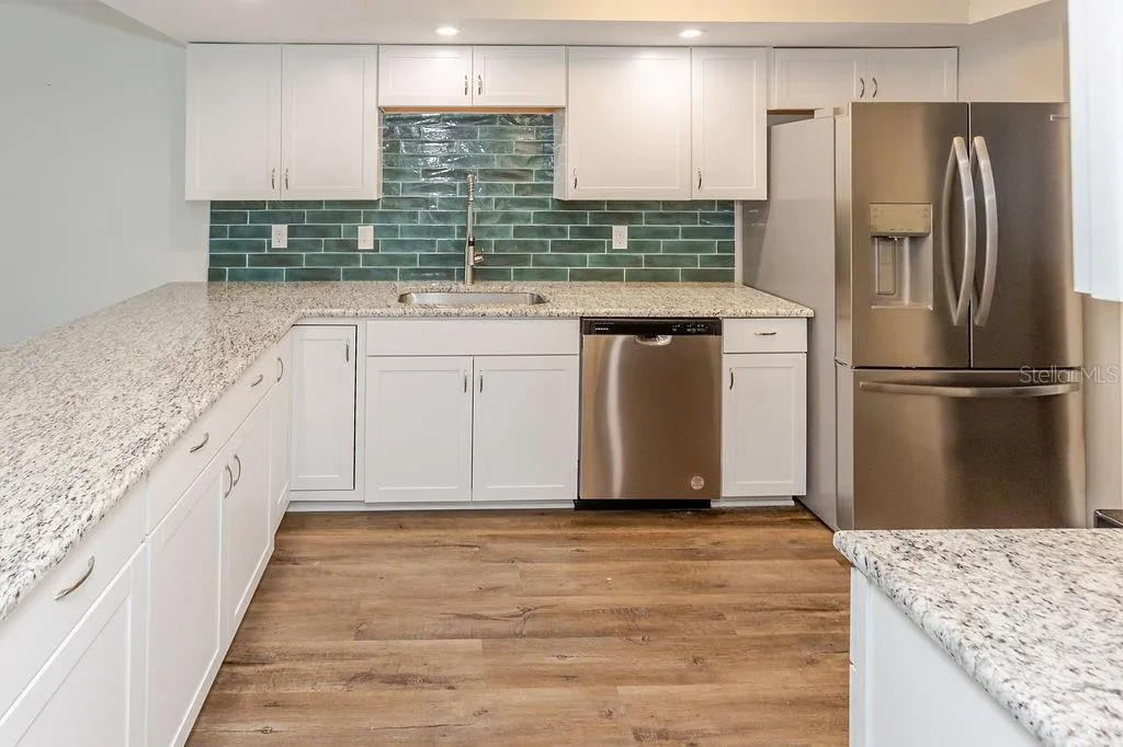 upgraded kitchen, granite and tile back splash