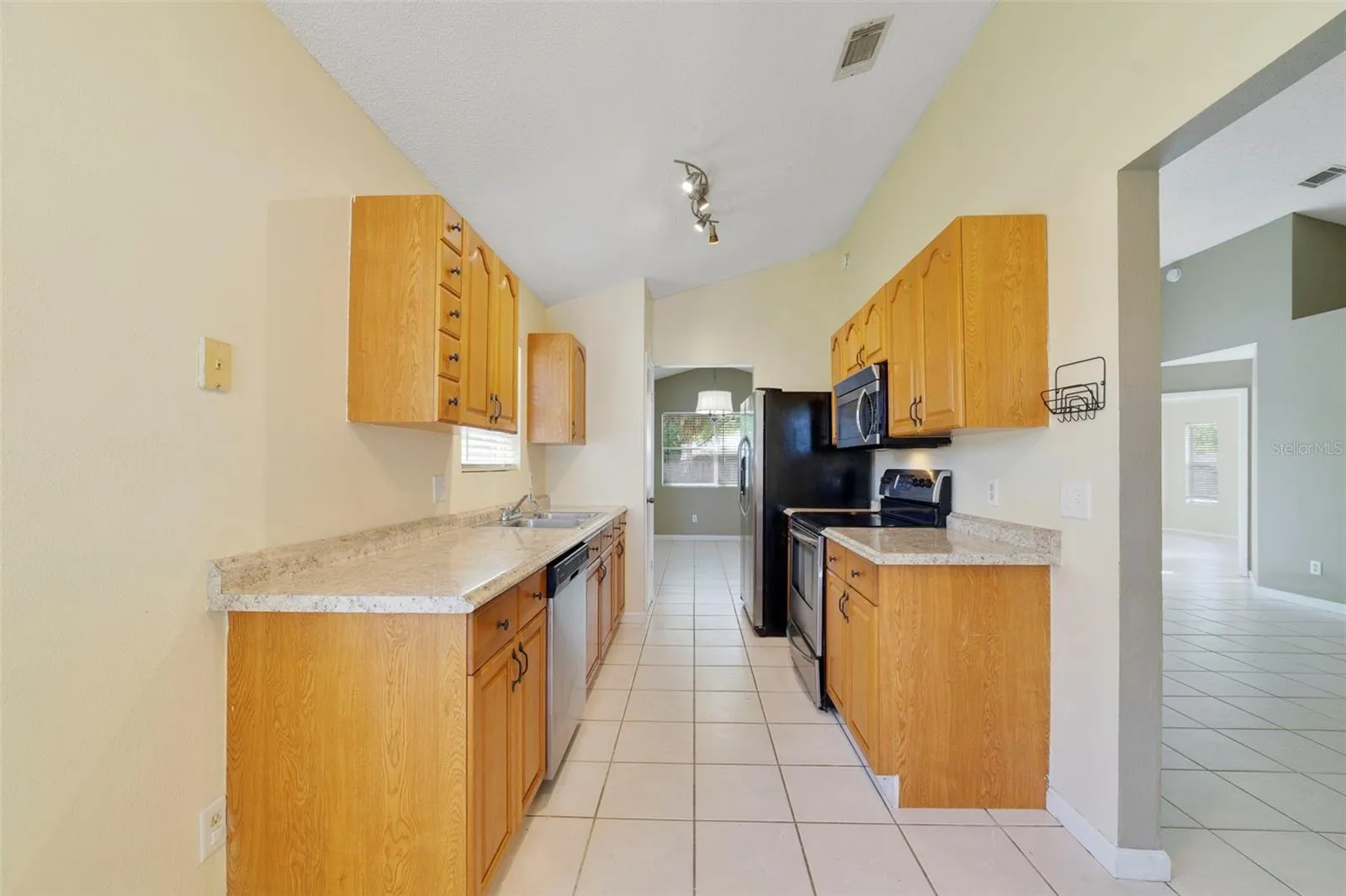 The Kitchen is conveniently located just off the main living spaces and features solid wood cabinetry, STAINLESS STEEL APPLIANCES, and a cozy, sunny BREAKFAST NOOK—a perfect spot for morning coffee or casual meals.